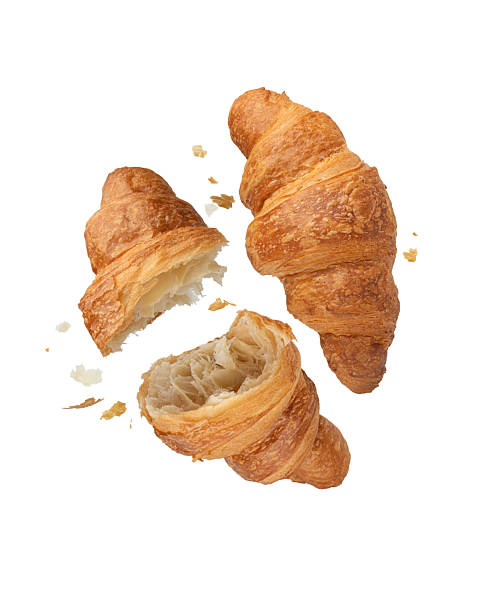istock Torn falling croissant with crumbs on white isolated background 2244370399