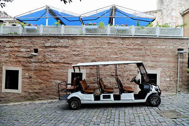 istock golf cart on the street 2244372174