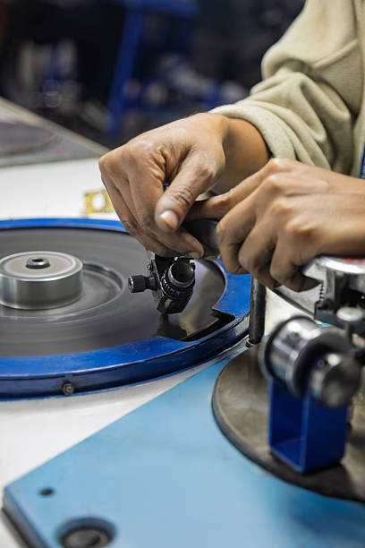 istock diamond polisher at work, using a polishing wheel to shape and refine a rough diamond. This process, brillianteering , is the final stage of diamond cutting. 2244375234