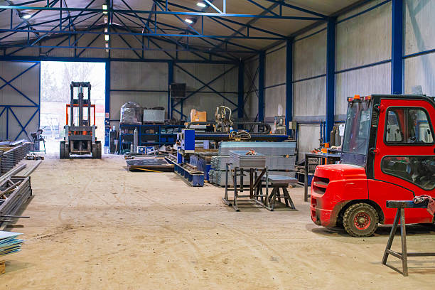 Huge industrial plasma cutter cutting steel plates in the factory.