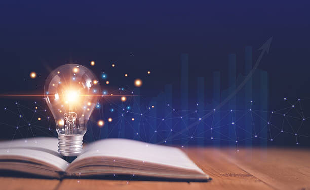 istock Light bulb on open book with growing graphs of stock market, Educational knowledge and business education concepts, Reading for inspiration and new idea to business grow in the future. 2244385910