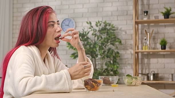 istock Woman Enjoying Healthy Snack at Cozy Kitchen Table 2244386671