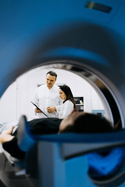 istock Individual receiving CT scan in clinical environment 2244386771
