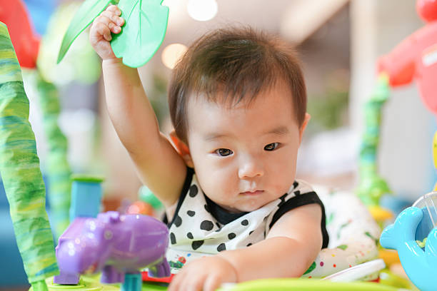 istock A baby is playing with a toy elephant 2244390950