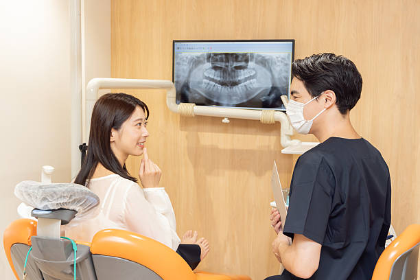 istock A dentist explaining the dental condition and treatment options to a patient 2244391875
