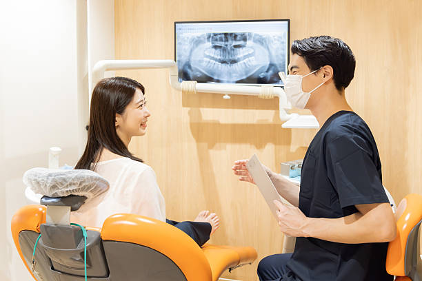 istock A dentist explaining the dental condition and treatment options to a patient 2244391915