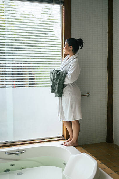 istock Woman relaxing next to bubble bath 2244392673
