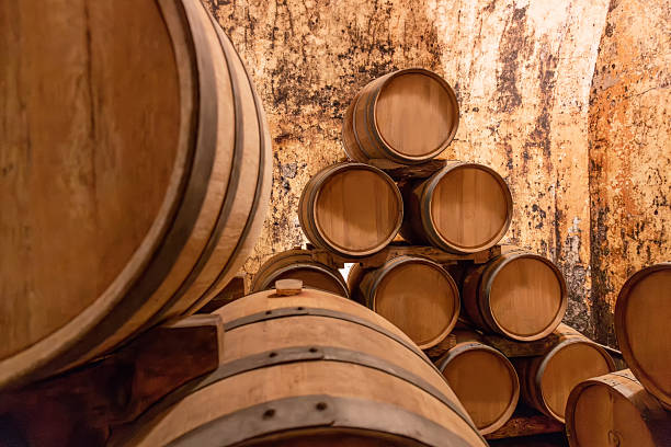 istock Wine barrels aging in a traditional underground cellar, showcasing the winemaking process and a rustic, authentic atmosphere 2244392896