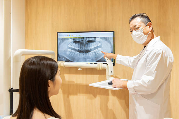 istock A dentist explaining the dental condition and treatment options to a patient 2244393988