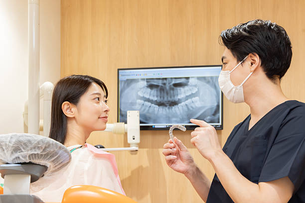 istock A male dentist explaining mouthpiece orthodontics 2244394938