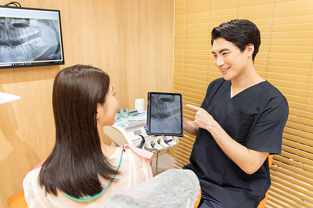 istock Dentist using tablet to explain dental treatment to patient 2244395033