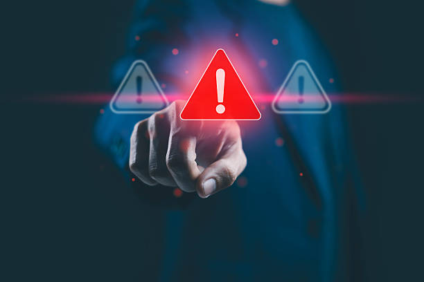 istock A businessman pointing at a glowing red warning icon with an exclamation mark, symbolizing cybersecurity alert, data protection risk, and digital system error concept in technology business. 2244395553