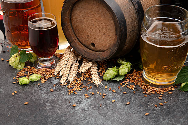 istock Craft beer assortment with wooden keg on stone table 2244396020