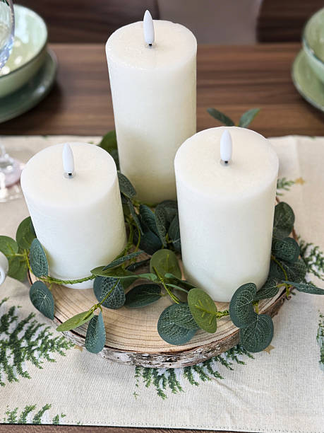 istock Image of elegant christmas dining table with green candles, festive runner, and tree pattern / holiday plate setting, cozy dinner ambiance 2244396032