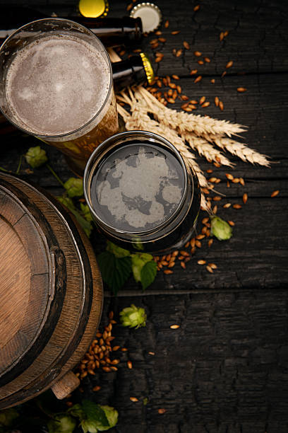 istock Dark beer and lager with wooden barrel and hops 2244396037