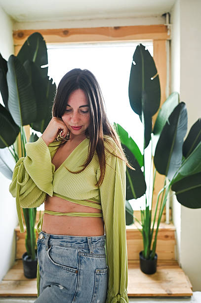 istock Thoughtful young woman wearing lime green wrap top 2244398705