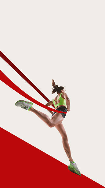 istock Bold poster. Female runner leaping forward breaking red ribbon in dynamic surreal motion 2244399832