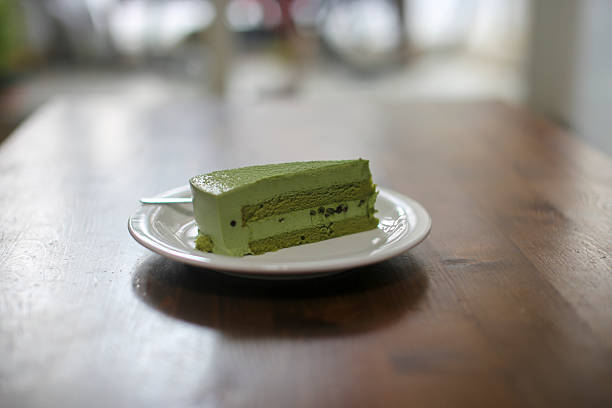 istock Delicious green tea flavored cake slice on wooden table 2244399997