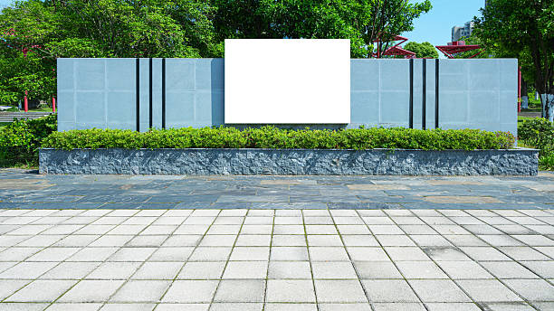 istock White billboard on the stone brick wall in public park 2244404812