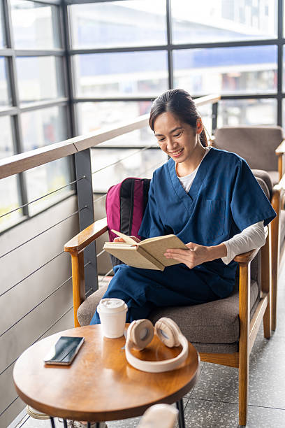 A Female Nurse Takes a Coffee Break at the Cafeteria