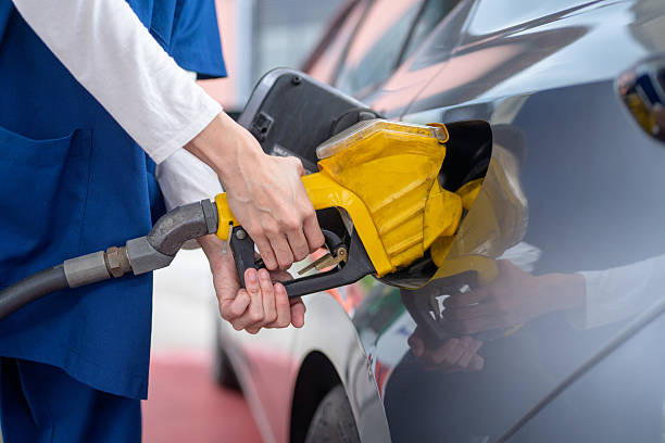 istock A woman refuels a car with gasoline using a fuel nozzle. 2244406796