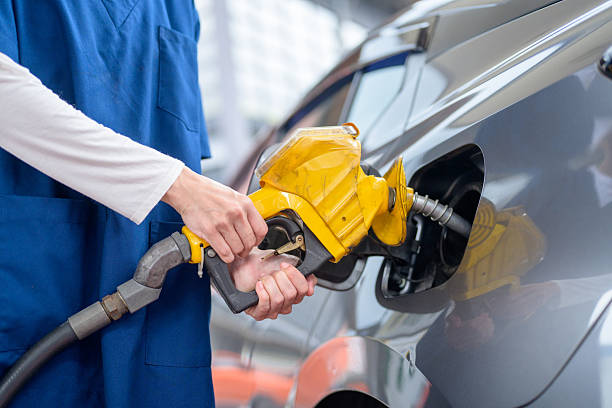 istock Woman refuels a car with gasoline using a gas gun 2244406799