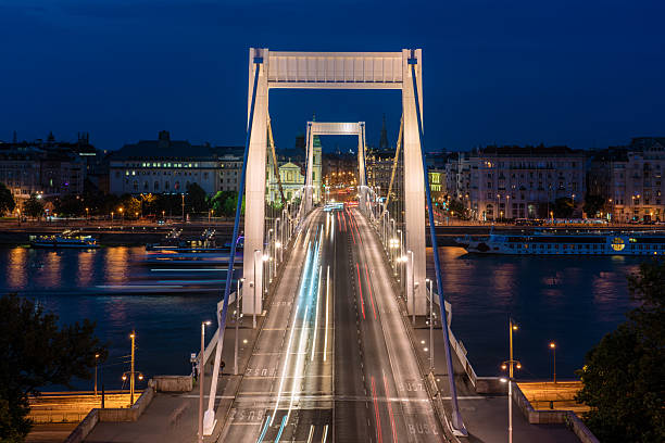 This is a night view of Elizabeth Bridge, a famous landmark along the River Danube on June 08, 2022 in Budapest, Hungary