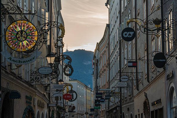 This is the Getreidegasse shopping street with shop signs and old traditional buildings on September 06, 2022 in Salzburg, Austria