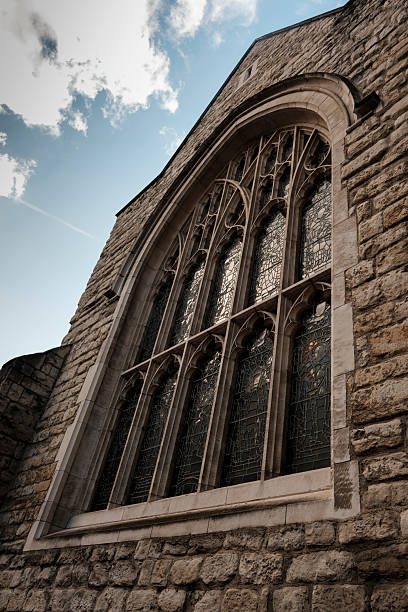 istock Gothic church window with stone wall and blue sky 2244413816
