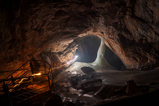 Ice cave. Winter violet landscape. Ice cave at moonlight.