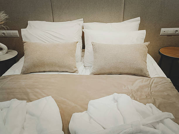 istock White and gray pillows on a bed with headboard. A place to rest and sleep. 2244416768