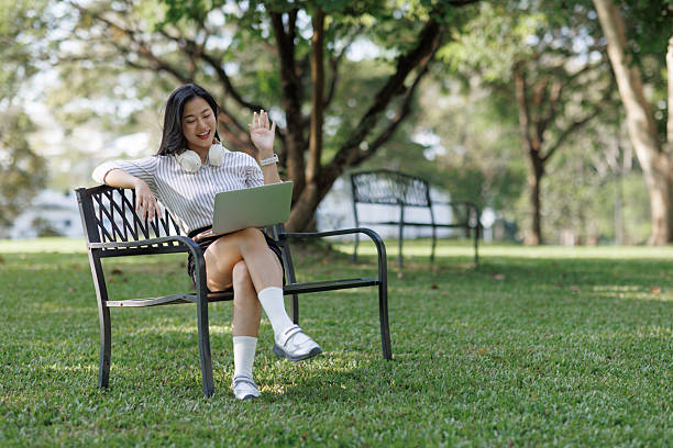 istock Woman making video call while working outdoors in park 2244419300