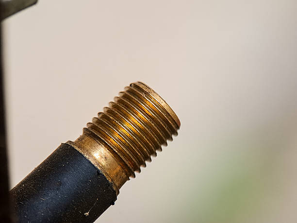 Detailed view showcasing the texture and pattern of a metallic screw thread and rubber base.