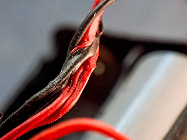 istock Intertwined red and black wires showcasing connectivity and complexity in a vivid color scheme. 2244420704