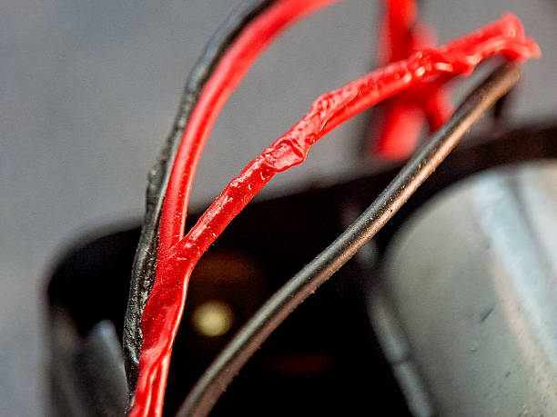 istock A vibrant red wire contrasts with a muted grey and black wire, creating a modern aesthetic view. 2244420722