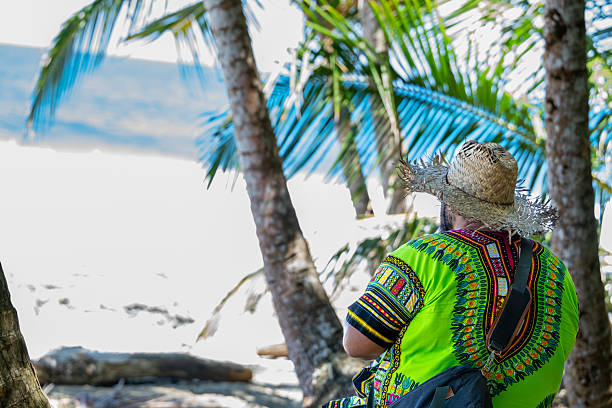 istock Latin American man wearing straw hat and dashiki at Caribbean beach 2244420933