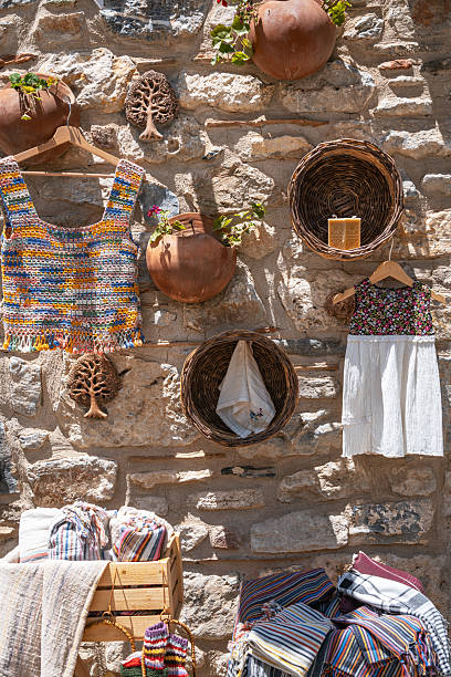istock Handmade crafts and textiles on a rustic stone wall 2244424141