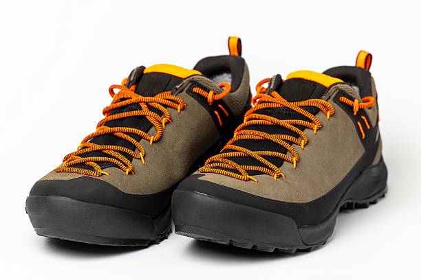 istock Beige hiking boots with colorful orange laces on a white background. 2244424155