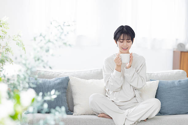 istock Asian woman drinking coffee to wake up 2244425224