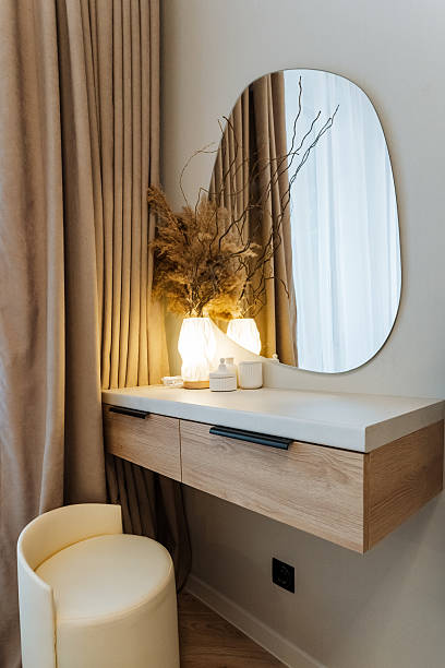 istock In a cozy and welldesigned bedroom, there is a beautifully crafted dressing table that includes a stylish mirror and a comfortable stool, creating a perfect grooming space 2244425644