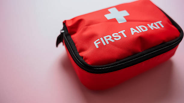 istock A bright red first aid kit is currently positioned on a soft pink surface, ready for any potential emergencies that may arise, providing essential health care support whenever needed 2244425667