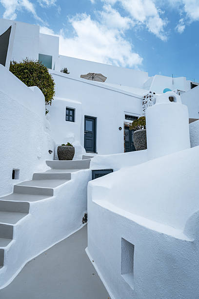 istock Whitewashed village architecture with winding stairs and paths in Santorini. 2244426998