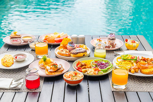 istock Delicious breakfast spread by pool with colorful fruits, pastries, 2244427876