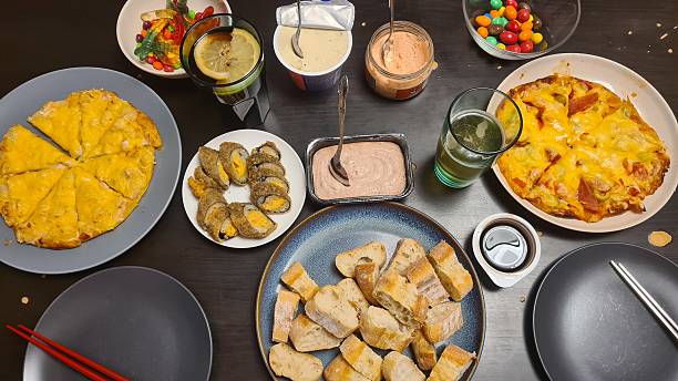 homemade snacks, appetizer table, family gathering, rustic presentation, finger foods, party platters, casual dining, comfort food, homemade delicacies, food variety, cozy atmosphere, traditional recipes, sharing board, home catering, festive table, culinary craftsmanship, natural lighting, high-resolution photo, food photography, domestic scene, hearty appetizers, homemade treats, snack assortment, communal table, DIY catering, warm hospitality, country style, homemade dishes, food preparation, inviting spread
