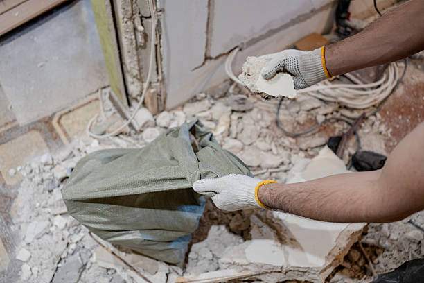 istock A man wearing work gloves manually cleans up the mess after demolition, filling a durable sack with construction waste and broken plaster on the renovation site. 2244432938