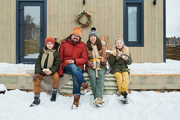 istock Family Enjoying Hot Drinks and Snacks Outdoors during Winter Vacation 2244434587