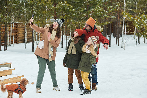 istock Family Taking Selfie Together Outdoors during Winter Vacation 2244435053