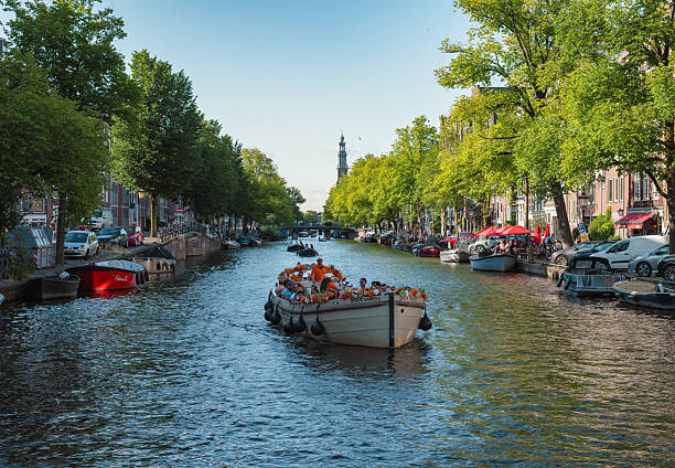 Canal cruise on the Amstel river in the centre of Amsterdam , the Netherlands