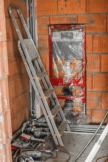 istock Metal ladder standing in room with various construction tools and equipment during home renovation. Concept of interior repair, home improvement, and building process. 2244440037