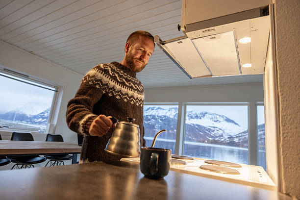 Man Pouring Hot Drink in Cozy Kitchen